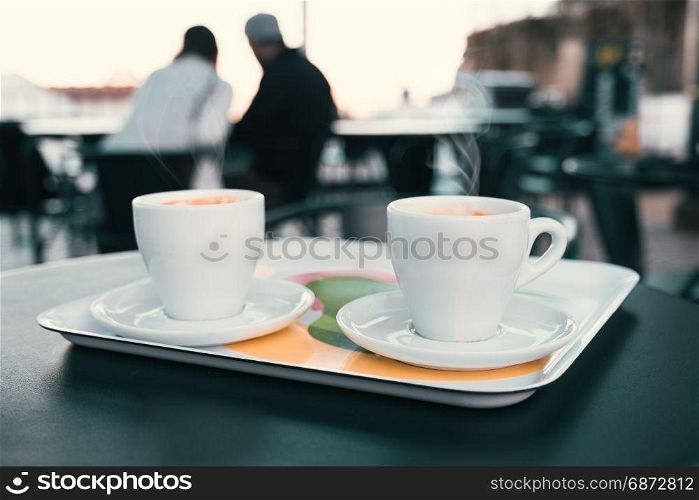 Cup of coffee on the street cafe table