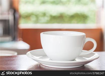 Cup of coffee on wooden counter, stock photo