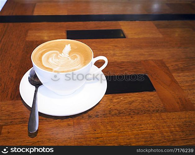 cup of coffee on wooden table.