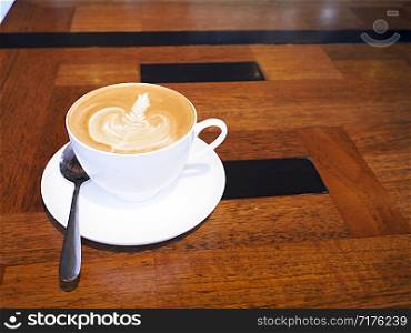 cup of coffee on wooden table.