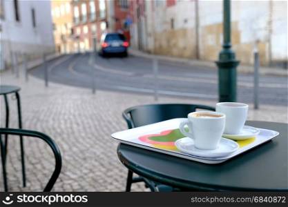 Cup of coffee over old european cityscape