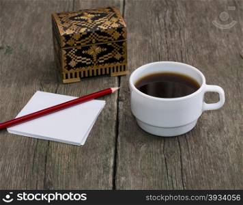 cup of coffee, pencil with paper and a casket, a still life, a subject drinks