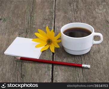 cup of coffee, pencil with paper and a yellow flower, a still life, on a wooden table, a subject flowers and drinks