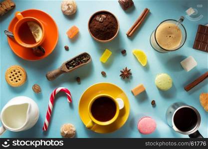 cup of coffee, tea and cacao at blue paper background