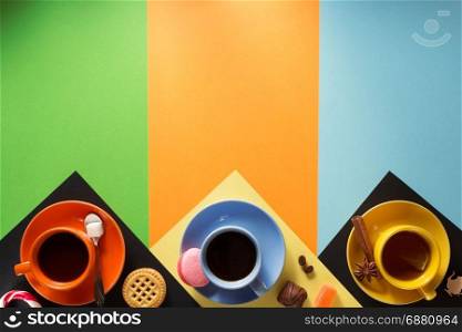 cup of coffee, tea and cacao at colorful background