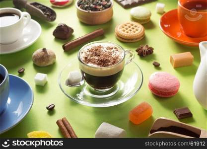 cup of coffee, tea and cacao at green paper background