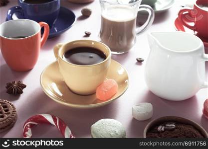 cup of coffee, tea and cacao at purple paper background
