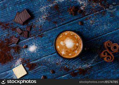 Cup of coffee with chocolate. Cup of cappuccino and cinnamon with chocolate with latte art of Universe