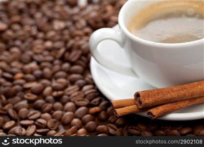 Cup of coffee with cinnamon. Focused on cinnamon