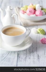 Cup of coffee with colored meringues