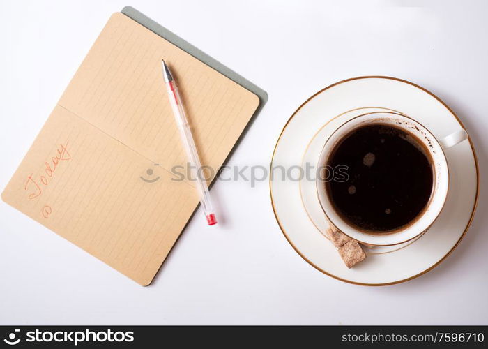 cup of coffee with diary, and care cosmetics around white background. life style flat lay