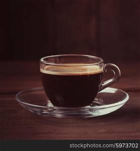 Cup of coffee with fume on the wooden background. Cup of coffee with fume