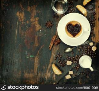 Cup of coffee with heart on foam and some ingredients