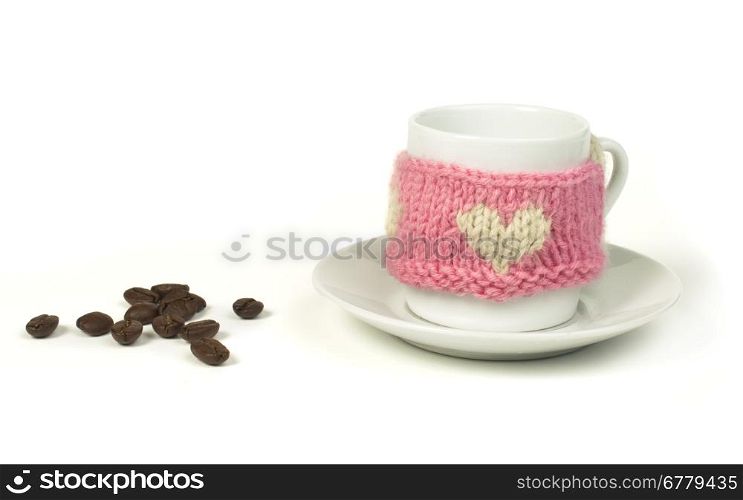 Cup of coffee with knitted heart symbol. White isolated.