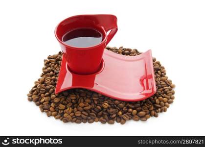 Cup of coffee with many beans around