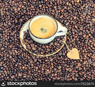 Cup of coffee with paper heart. Love concept. Vintage style toned picture