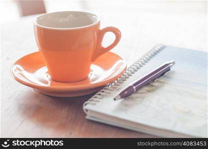Cup of coffee with pen and spiral notebook, stock photo