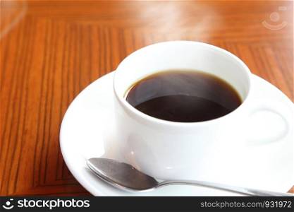 cup of coffee with smoke on the wooden table