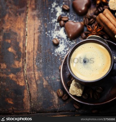 Cup of coffee with sugar, chocolate and spices