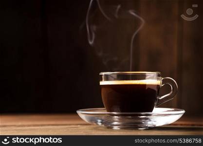Cup of coffee with &#xA;fume on the wooden background