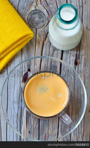 Cup of espresso and milk on old wood