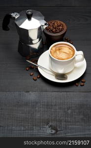 Cup of espresso coffee and mocha coffee maker on dark wooden background.. Cup of espresso coffee and mocha coffee maker on dark wooden background