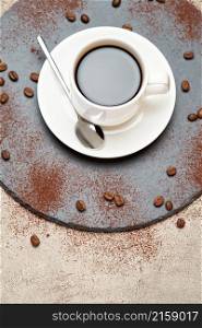 Cup of espresso coffee on a stone serving board on concrete background.. Cup of espresso coffee on a stone serving board on concrete background