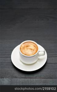 Cup of espresso coffee on dark wooden background.. Cup of espresso coffee on dark wooden background