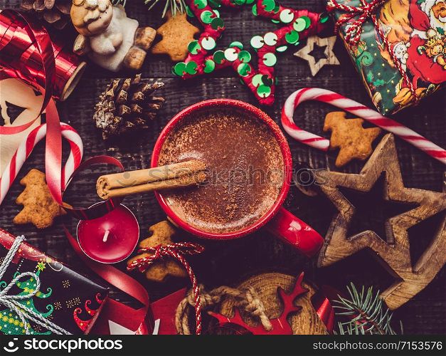 Cup of flavored cocoa, cinnamon stick and Christmas decorations. View from above, close-up, flat lay. Congratulations to loved ones, family, relatives, friends and colleagues. Merry Christmas and Happy New Year. Beautiful card