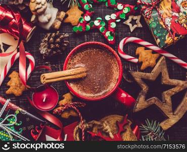 Cup of flavored cocoa, cinnamon stick and Christmas decorations. View from above, close-up, flat lay. Congratulations to loved ones, family, relatives, friends and colleagues. Merry Christmas and Happy New Year. Beautiful card