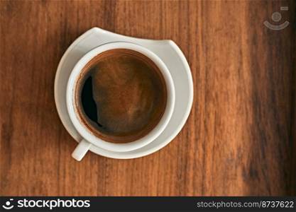 Cup of fresh and aroma black coffee on wooden table. . Cup of fresh and aroma black coffee