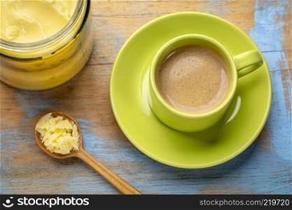 cup of fresh fatty coffee with ghee (clarified butter) - ketogenic diet concept