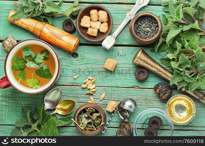 Cup of fresh herbal tea with melissa on wooden table.Herbal tea ingredients. Cup of herbal tea with melissa