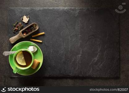 cup of green tea and slate background
