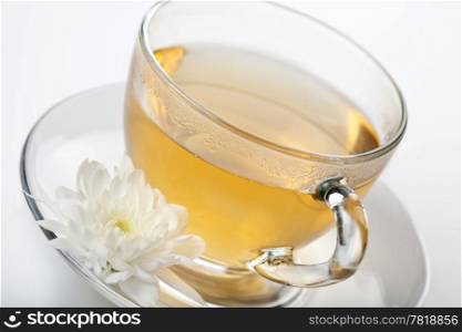 cup of green tea and white flower