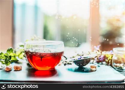 Cup of Healthy herbal tea on table at window still