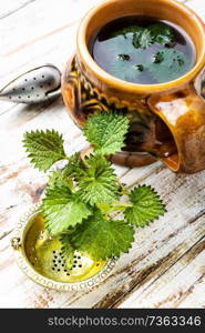Cup of healthy herbal tea with nettle.Nettle tea. Healing tea with nettle
