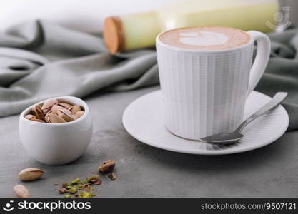 Cup of heart latte art and pistachios