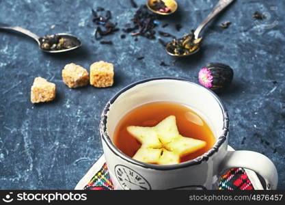 Cup of herbal tea decorated with star with apple