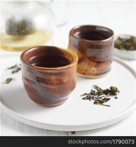 Cup of herbal tea with various herbs on white background. Cup of herbal tea with various herbs