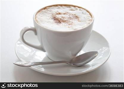 Cup of hot cappuccino, close-up. Natural shooting