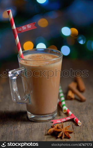 Cup of hot cocoa beverage and Christmas tree lights