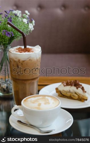 Cup of hot Coffee with Banoffee pie and ice coffee. coffee and pie