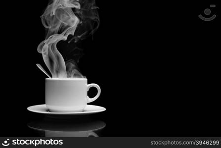 Cup of hot drink with steam over black background