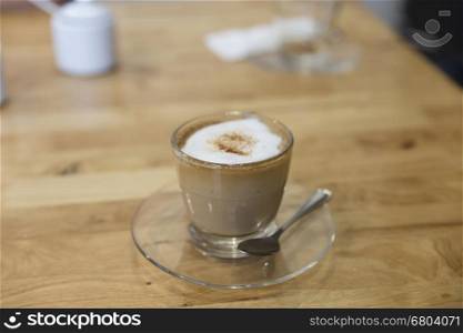 cup of hot espresso coffee on wooden table