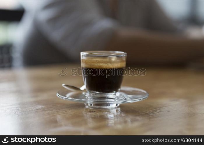 cup of hot espresso coffee shot on wooden table
