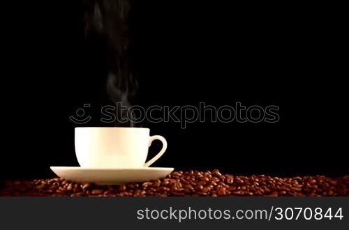 Cup of hot fresh coffee on beans