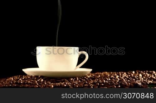 Cup of hot fresh coffee on beans