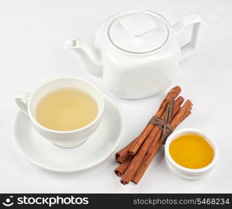 Cup of hot linden tea with cinnamon sticks, and honey