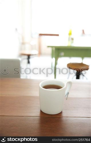 Cup of hot tea on wood background